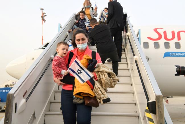 People walking off an aeroplane in Israel after making aliyah