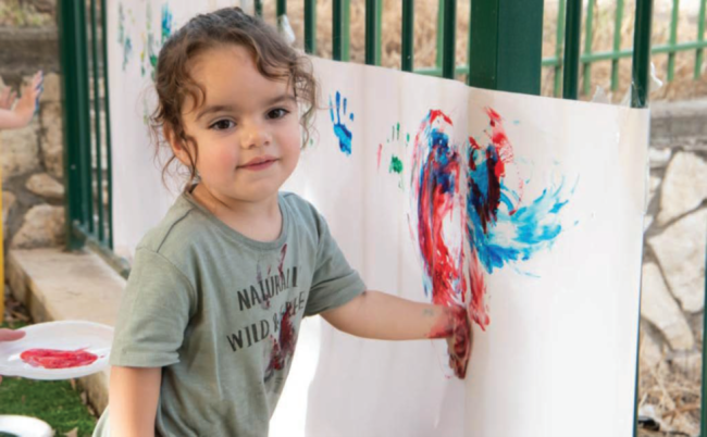Child in heartbeats painting a picture